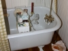 Antique claw foot tub in bath by nook